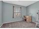 Bedroom featuring grey carpeting, a window for natural light, and wood desk with chair at 5160 Hannibal St, Denver, CO 80239