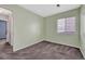 Cozy bedroom with light green walls, carpet, a closet and a window for natural light at 5160 Hannibal St, Denver, CO 80239