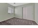Bedroom with light green walls, carpet, and a large window for natural light at 5160 Hannibal St, Denver, CO 80239
