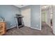 Bedroom with neutral walls and carpet features a treadmill and closet for organization at 5160 Hannibal St, Denver, CO 80239