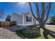 View of the side of the home with lawn, landscaping and partial shade at 5160 Hannibal St, Denver, CO 80239