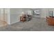 Spacious living room with neutral colors, plush carpet, and front door at 5160 Hannibal St, Denver, CO 80239