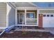 Close up of the covered front porch with white railings and brick accent at 5160 Hannibal St, Denver, CO 80239