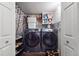 Well-organized laundry room features a new washer and dryer and storage at 4011 W Kenyon Ave, Denver, CO 80236