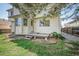 Exterior shot of the backyard, showing a wooden deck, green lawn and a white siding at 11305 W Crestline Dr, Littleton, CO 80127