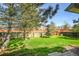 Spacious backyard featuring a lush lawn and a wooden fence providing privacy at 11305 W Crestline Dr, Littleton, CO 80127