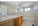 Bathroom with a vanity, sink, mirror, toilet and tiled tub/shower at 11305 W Crestline Dr, Littleton, CO 80127
