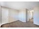 Neutral bedroom with carpeted floors and closet doors, ready for personalization at 11305 W Crestline Dr, Littleton, CO 80127