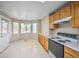 Bright breakfast nook featuring white tile floors, wood cabinets, and large windows offering natural light at 11305 W Crestline Dr, Littleton, CO 80127