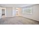 Main bedroom with neutral walls and carpet, leading to the main bath at 11305 W Crestline Dr, Littleton, CO 80127