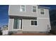 Rear view of a two-story house featuring sliding glass doors and a patio at 20108 Randolph Pl, Denver, CO 80249