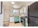 Charming kitchen with mint cabinets and butcher block counters at 4330 Bruce Randolph Ave, Denver, CO 80207