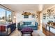 Living room with teal couch and wood floors, featuring gallery wall at 4330 Bruce Randolph Ave, Denver, CO 80207