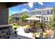 Relaxing back patio with an outdoor seating area and beautiful landscaping at 599 Fall River Ct, Brighton, CO 80601