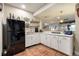 Basement bar area featuring white cabinets, countertops, and a mini fridge at 599 Fall River Ct, Brighton, CO 80601