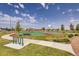 Community basketball court featuring a green and red surface with benches and surrounding greenery at 599 Fall River Ct, Brighton, CO 80601