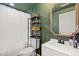 Bathroom featuring an olive color, decorative shelving, and modern fixtures at 599 Fall River Ct, Brighton, CO 80601