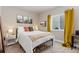 Cozy bedroom with natural light, neutral decor, and a comfortable bed at 599 Fall River Ct, Brighton, CO 80601