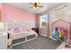 Bedroom featuring a decorated wall and a window with a view of the neighborhood at 599 Fall River Ct, Brighton, CO 80601