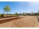 Bocce ball court with a well-maintained sand surface surrounded by landscaped gardens and trees at 599 Fall River Ct, Brighton, CO 80601