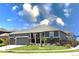 Charming single-story home featuring a well-manicured lawn, stone accents, and an attached two-car garage at 599 Fall River Ct, Brighton, CO 80601