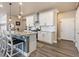 Bright kitchen with white cabinetry, stainless steel appliances, granite counters, and an island with seating at 599 Fall River Ct, Brighton, CO 80601