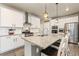 Modern kitchen featuring white cabinets, granite countertops, stainless steel appliances, and a large island at 599 Fall River Ct, Brighton, CO 80601