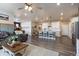 Open-concept kitchen, dining and living areas with hardwood floors, stainless steel appliances, and an open floorplan at 599 Fall River Ct, Brighton, CO 80601