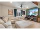 The living room features a large sectional, flat-screen TV and lots of space at 599 Fall River Ct, Brighton, CO 80601
