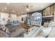 Spacious open-concept living room and kitchen area featuring a fireplace and breakfast bar at 599 Fall River Ct, Brighton, CO 80601