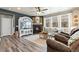Cozy living room features a fireplace, hardwood floors, large windows, and neutral-toned furnishings at 599 Fall River Ct, Brighton, CO 80601