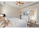 Bright main bedroom features a ceiling fan, TV, walk-in closet and attached bathroom at 599 Fall River Ct, Brighton, CO 80601
