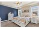 Serene main bedroom with a tray ceiling, accent wall, and a view of the neighborhood at 599 Fall River Ct, Brighton, CO 80601