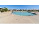 Large community pool with clear blue water, lounge chairs, and umbrellas in a residential area at 599 Fall River Ct, Brighton, CO 80601