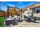 Backyard patio with outdoor seating, dining set, grill, and a peaceful fire pit area at 3303 Blue Grass Cir, Castle Rock, CO 80109
