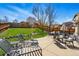 Amazing backyard with patio, lush green lawn, comfortable seating, and elegant patio furniture at 3303 Blue Grass Cir, Castle Rock, CO 80109