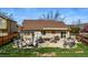 Lush backyard with patio seating, fire pit, grill, and well-manicured landscaping at 3303 Blue Grass Cir, Castle Rock, CO 80109