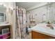 Bathroom featuring dual sinks, shower-tub combination, and seashell-themed decor at 3303 Blue Grass Cir, Castle Rock, CO 80109