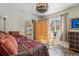 Bright bedroom with wood-look flooring, ceiling fan, and a window letting in natural light at 3303 Blue Grass Cir, Castle Rock, CO 80109