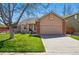 Charming home featuring a well-manicured lawn, brick accents, and a convenient two-car garage at 3303 Blue Grass Cir, Castle Rock, CO 80109