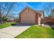 Side view of the home featuring a spacious two-car garage and well-maintained landscaping at 3303 Blue Grass Cir, Castle Rock, CO 80109