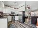 Modern kitchen featuring white cabinets, stainless steel appliances, and hardwood floors at 3303 Blue Grass Cir, Castle Rock, CO 80109