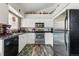 Stylish kitchen with white cabinets, stainless steel appliances, and granite countertops at 3303 Blue Grass Cir, Castle Rock, CO 80109