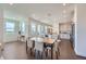 Open concept dining area with modern light fixtures that flows into a large, bright kitchen at 6880 Bryant Way, Denver, CO 80221