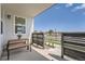 Welcoming front porch featuring a bench, a fence, and a landscaped yard at 6880 Bryant Way, Denver, CO 80221