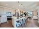 Modern kitchen with white countertops, stainless steel appliances, and large island with bar seating at 6880 Bryant Way, Denver, CO 80221