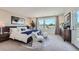 Spacious main bedroom features an accent wall, neutral colors, and lots of natural light at 6880 Bryant Way, Denver, CO 80221