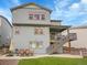 Exterior of home with a spacious backyard featuring a patio, a deck and a dining area at 7012 S Undergrove Way, Aurora, CO 80016