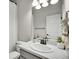 A well-lit bathroom featuring a white marble countertop, oval sink, and neutral tones for a clean and modern look at 7012 S Undergrove Way, Aurora, CO 80016