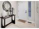 Welcoming entryway featuring a decorative mirror, a stylish table, and a warm welcome mat at the front door at 7012 S Undergrove Way, Aurora, CO 80016